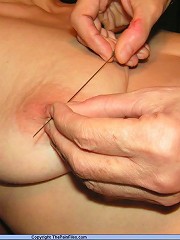 Submissive slave gets her nipples painfuly pierced with needles